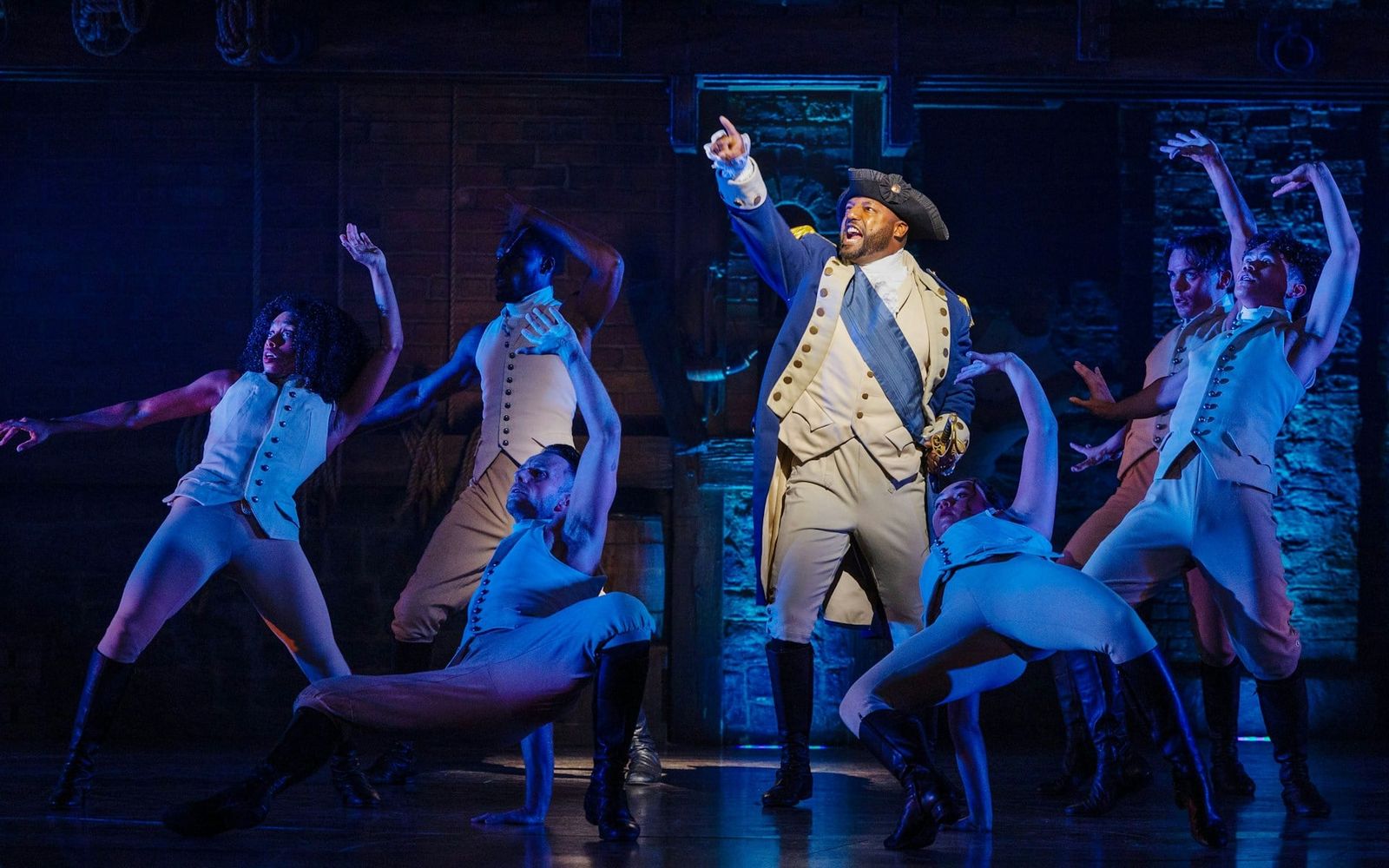 Hamilton cast performing on stage at the Victoria Palace Theatre in London